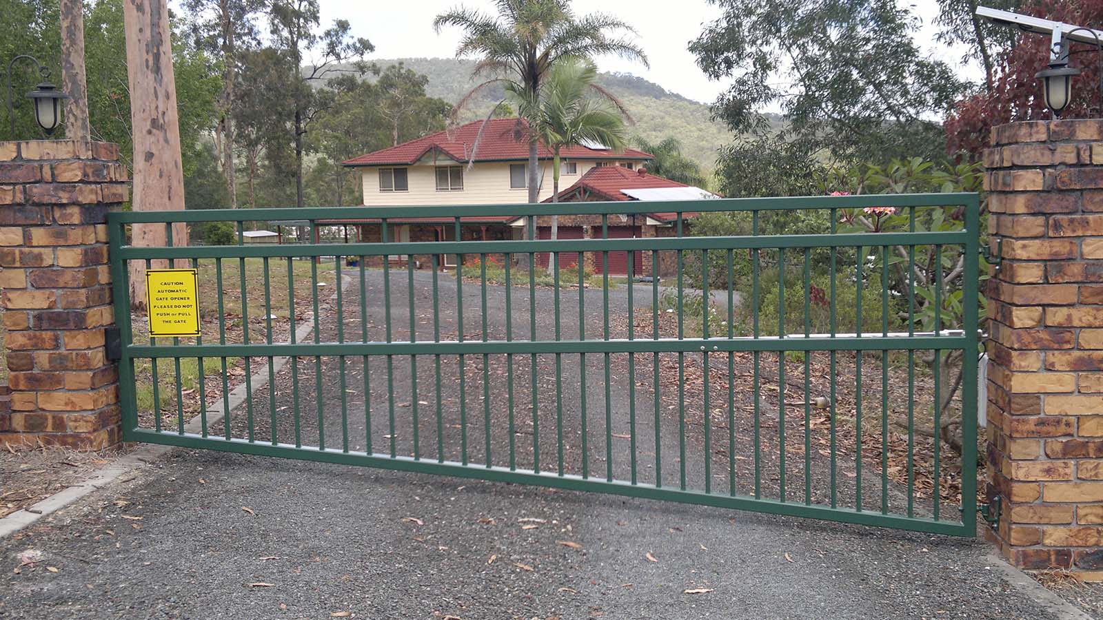swing gate on a gradient fall across the driveway, sliding gate, driveway gate, front gate, driveway gates brisbane