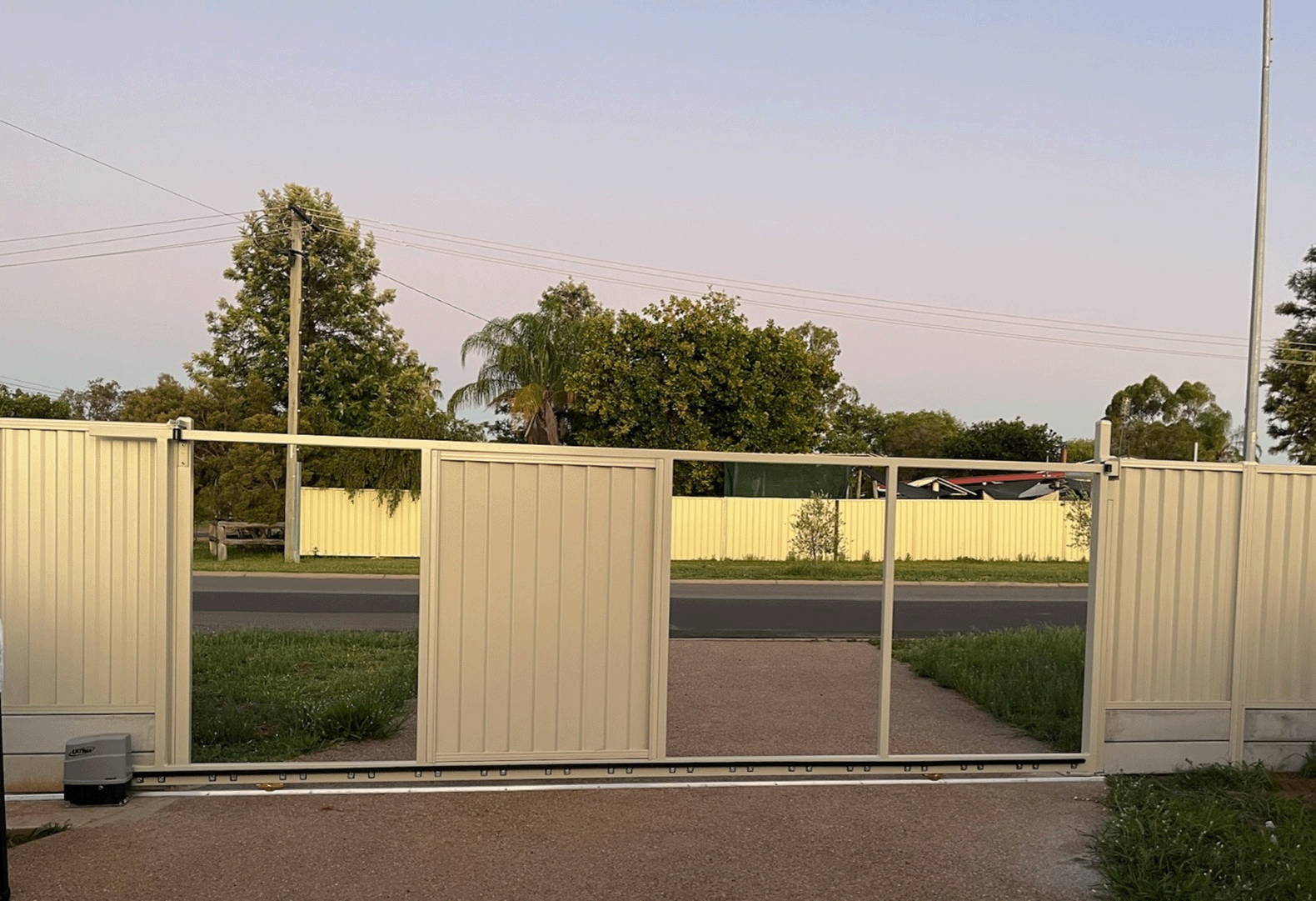 installing colour bond sheets into a driveway gate